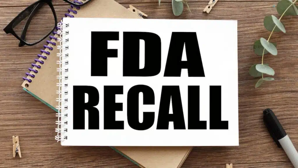 FDA recall. text on white paper over torn paper background.