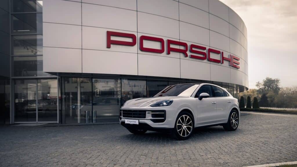 Brand new Porsche Cayenne in front of dealership