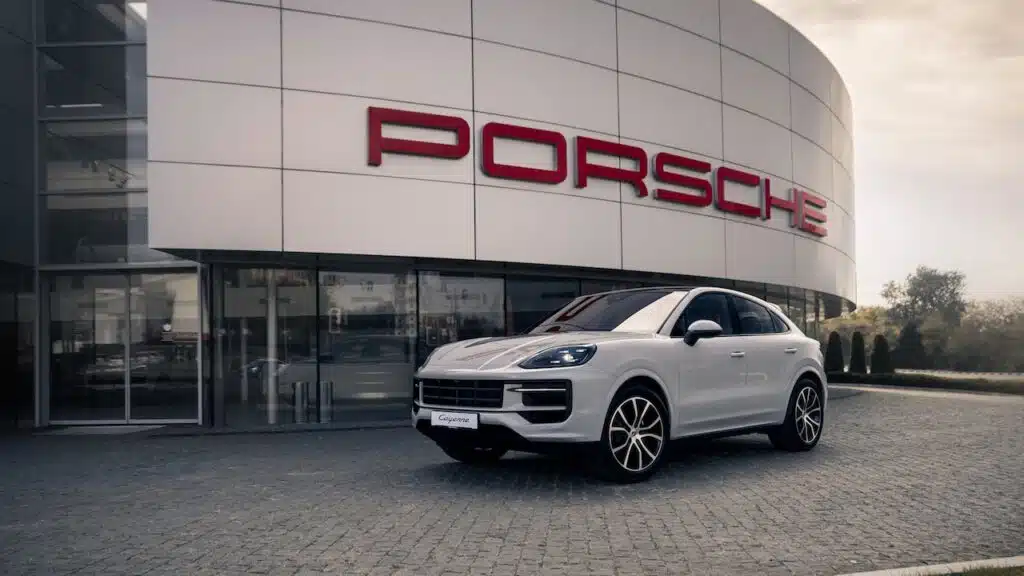 Brand new Porsche Cayenne in front of dealership