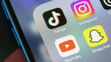 TikTok, Instagram, YouTube, and Snapchat app icons are seen on an iPhone.