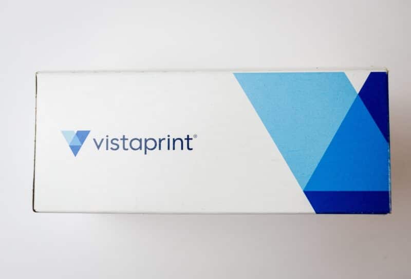 Cardboard box of Vistaprint business cards isolated on white background