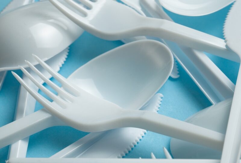 Plastic cutlery, forks, spoons and knives.