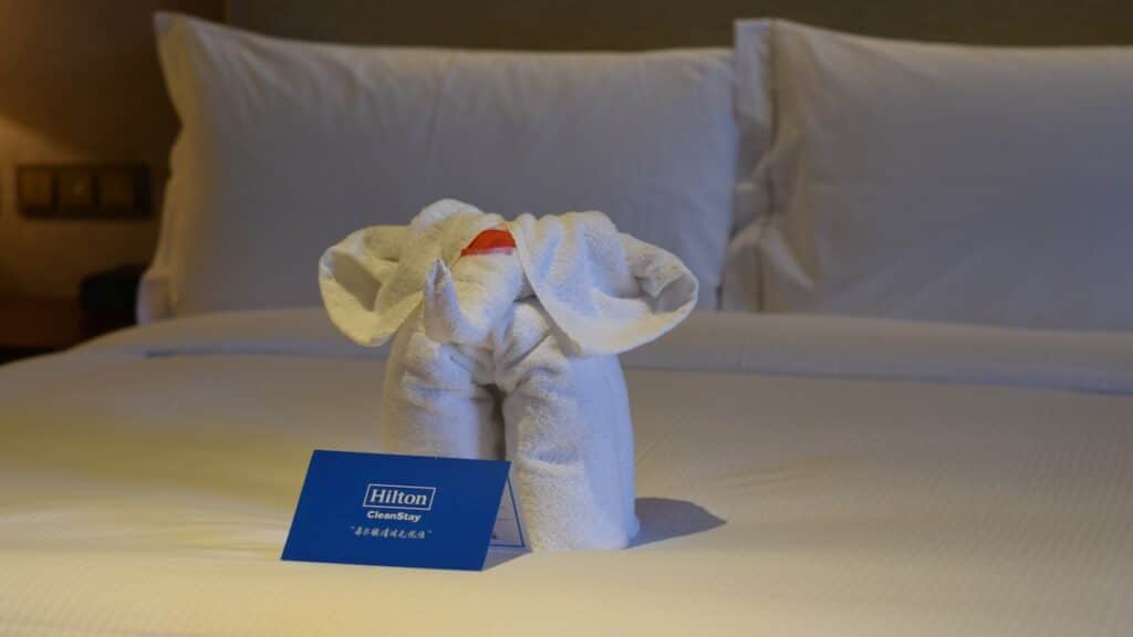 Towels and wash cloth folded into an elephant on a bed in a deluxe room at Hilton Golden Beach Hotel during the corona virus pandemic.