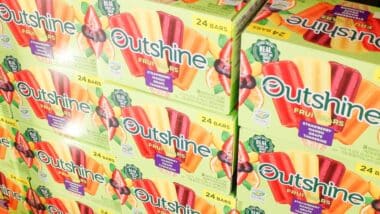 A view of several cases of Outshine fruit bars, on display at a local big box grocery store.