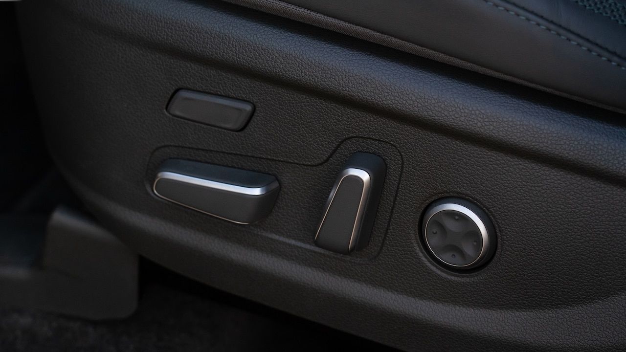 Electric car seat adjustment control panel close up view