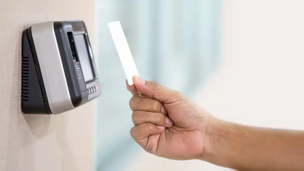 Proximity card reader door unlock, Hand security man using ID card on fingerprint scanning access control system for identity verification to open the door or for security safety or check attendance.