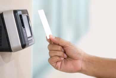 Proximity card reader door unlock, Hand security man using ID card on fingerprint scanning access control system for identity verification to open the door or for security safety or check attendance.