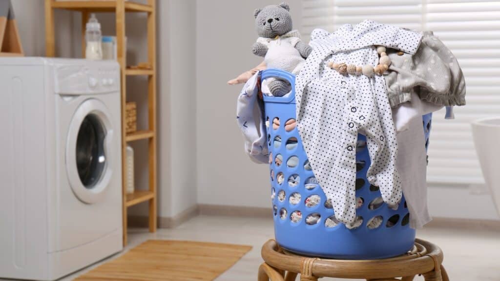 Laundry basket with baby clothes and crochet toy