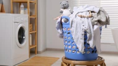 Laundry basket with baby clothes and crochet toy
