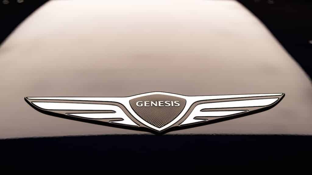 Genesis car hood or bonnet emblem or badge on a sedan displayed in showroom