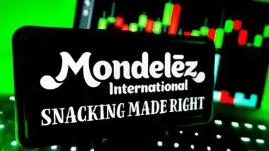 Mondelez International Company Logo Branding on Screen with Stock Chart Market Trends in Background with LED Vibrant Lighting