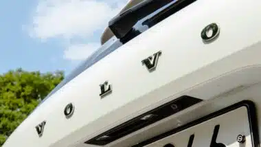 A close-up of the rear of a white Volvo XC60 showing the brand lettering and rearview camera.
