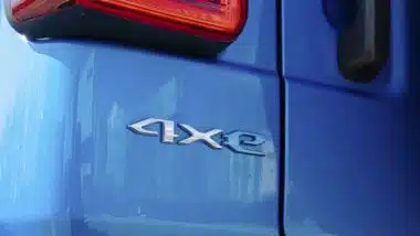 A detailed view of the '4xe' badge on a blue Jeep Wrangler