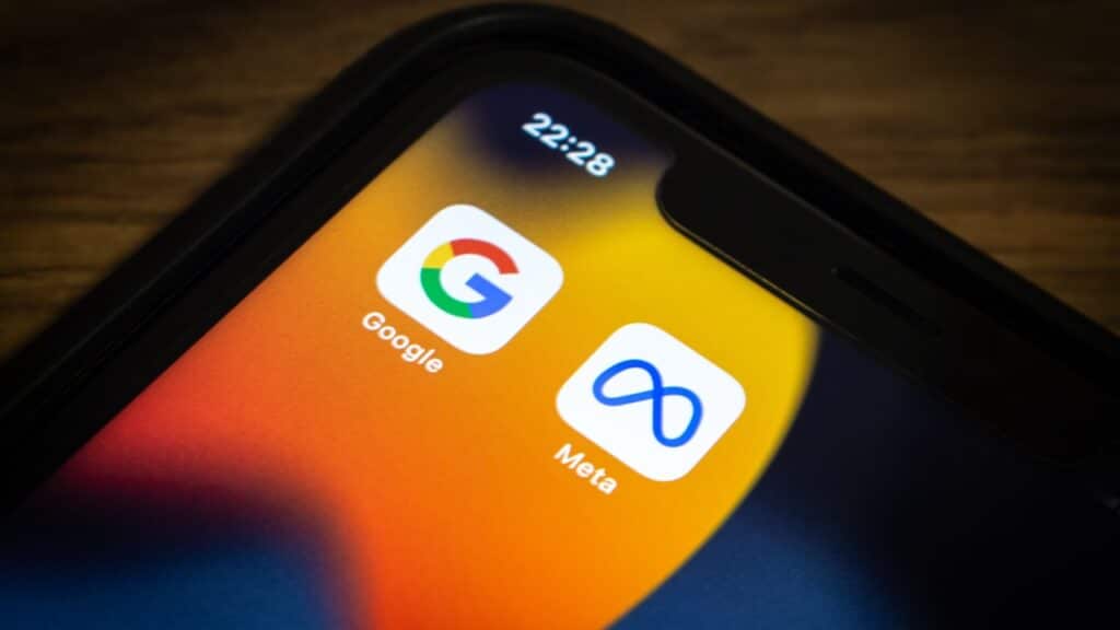 Closeup icons of Google and Meta on an iPhone