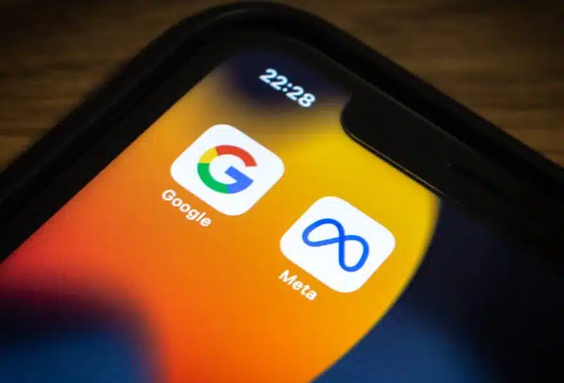 Closeup icons of Google and Meta on an iPhone
