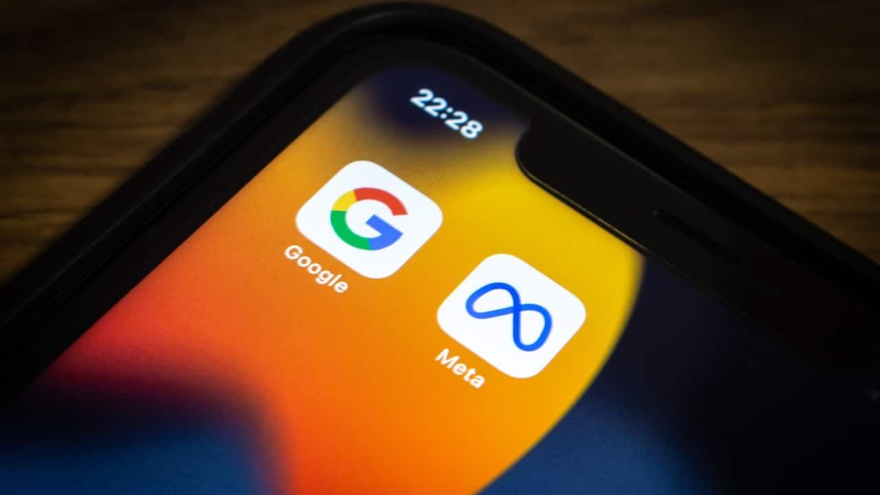 Closeup icons of Google and Meta on an iPhone