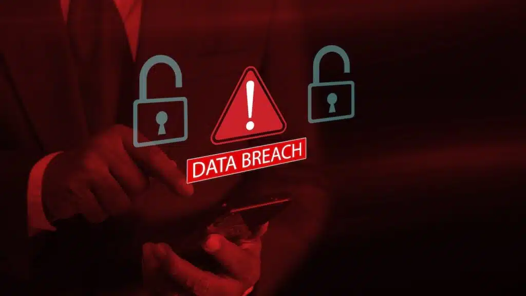 Businessman using smartphone system hacked warning alert with red open padlock icon and warning signs.