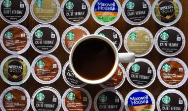 A cup of coffee on top of assorted Keurig k-cup pods.