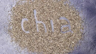 dark Chia seeds with Chia inscription on a black stone background.