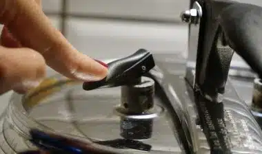 Woman depressurizing pressure cooking pushing on the safety valve