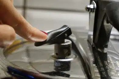 Woman depressurizing pressure cooking pushing on the safety valve
