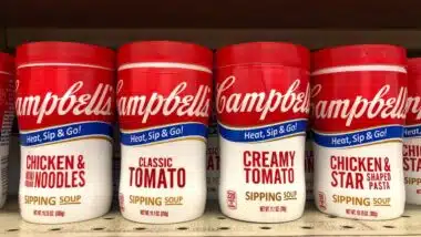 shelf with containers of Campbell's Chicken Noodle, Chicken Stars, Classic and Creamy tomato Soups in convenient to go cups. Microwavable