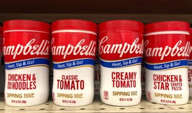 shelf with containers of Campbell's Chicken Noodle, Chicken Stars, Classic and Creamy tomato Soups in convenient to go cups. Microwavable
