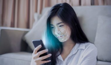 Asian female using mobile smartphone scanning face