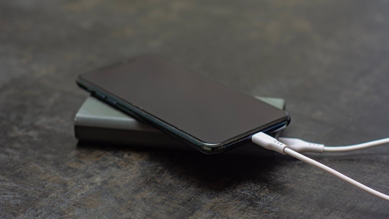 Portable charger charges a smartphone