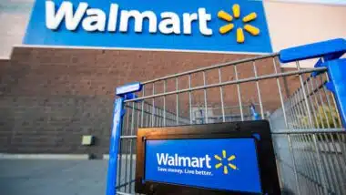 Los Angeles USA A Walmart shopping cart in focus with the store's blue logo and slogan, "Save money. Live better," on a sunny day.