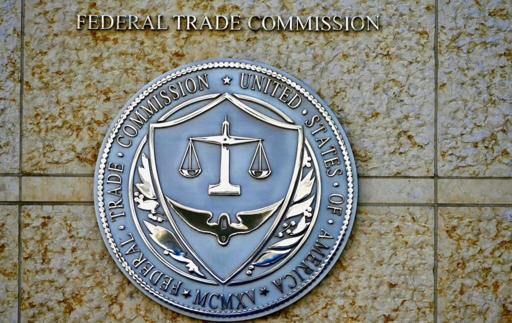 Seal of the Federal Trade Commission (FTC) outside the entrance to a government building in downtown Washington.