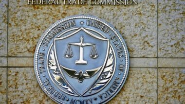 Seal of the Federal Trade Commission (FTC) outside the entrance to a government building in downtown Washington.