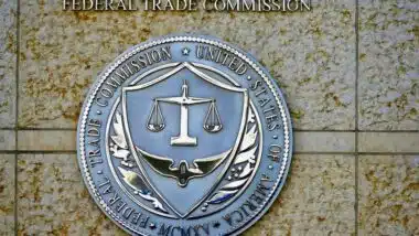 Seal of the Federal Trade Commission (FTC) outside the entrance to a government building in downtown Washington.