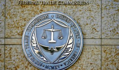 Seal of the Federal Trade Commission (FTC) outside the entrance to a government building in downtown Washington.