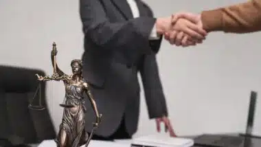Client shakes hands with lawyer