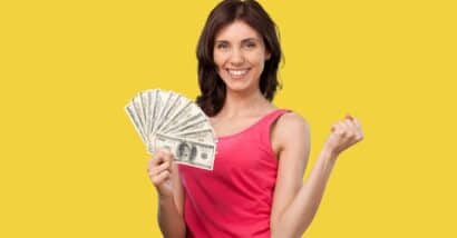 Young happy smart rich woman hold in hand cash money