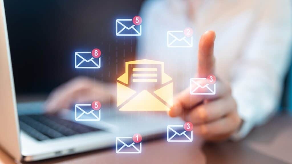 A person uses a laptop to check emails