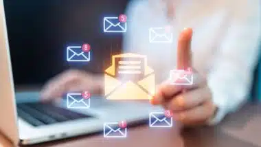 A person uses a laptop to check emails