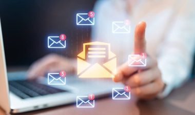 A person uses a laptop to check emails