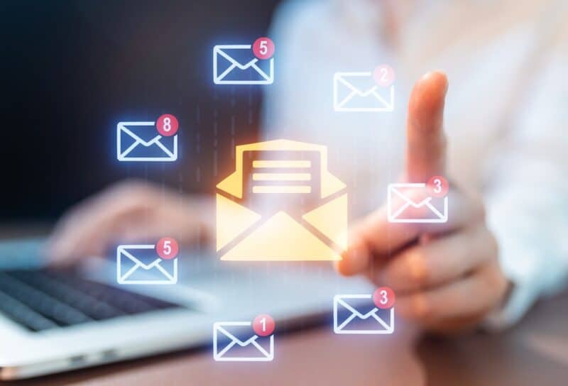 A person uses a laptop to check emails