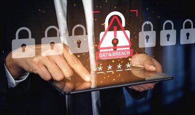 Businessman with Tablet Facing Data Breach Alert on Screen