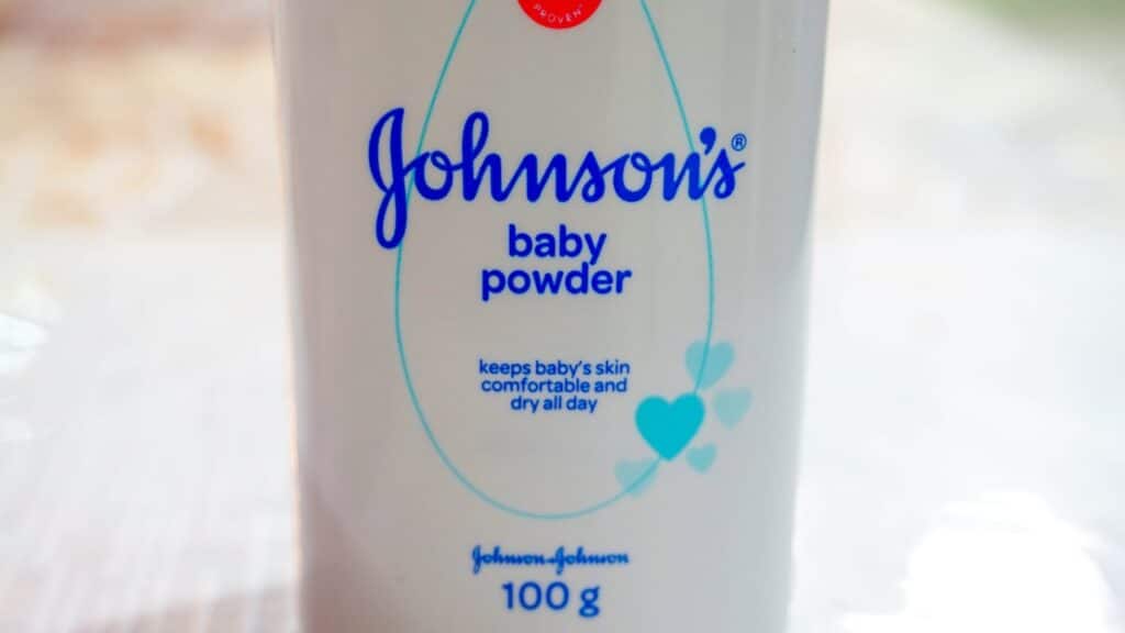 Close up image of white bottle of Johnson's baby powder isolated on table.