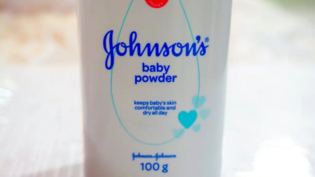 Close up image of white bottle of Johnson's baby powder isolated on table.