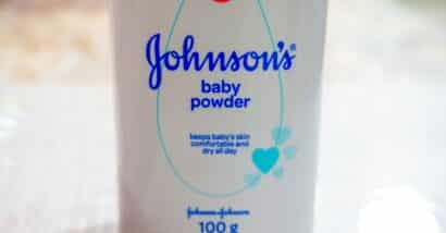Close up image of white bottle of Johnson's baby powder isolated on table.
