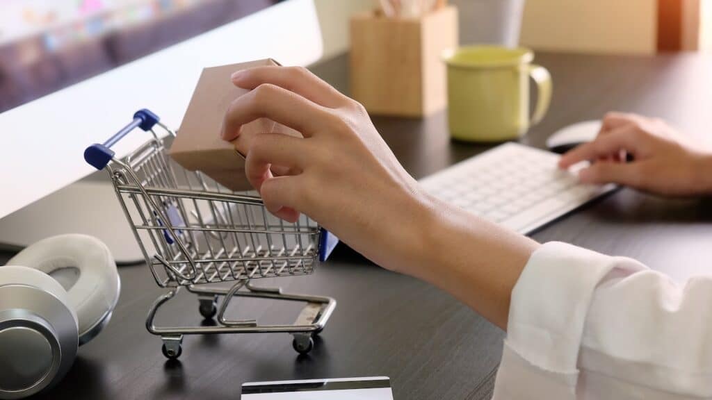 Boxes in a trolley with Woman hands, Shopping online concept.