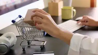 Boxes in a trolley with Woman hands, Shopping online concept.