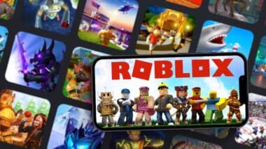 Roblox mobile game app on smartphone screen with the game blurred on background.