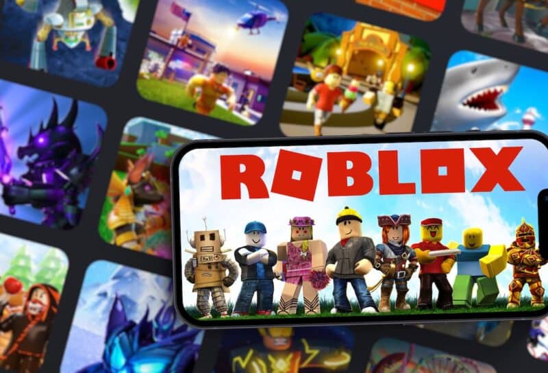 Roblox mobile game app on smartphone screen with the game blurred on background.