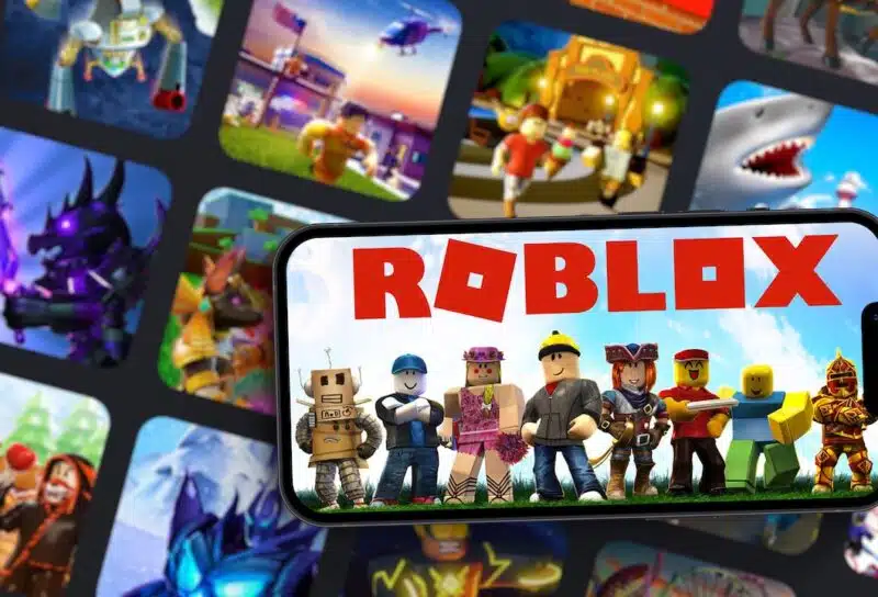 Roblox mobile game app on smartphone screen with the game blurred on background.