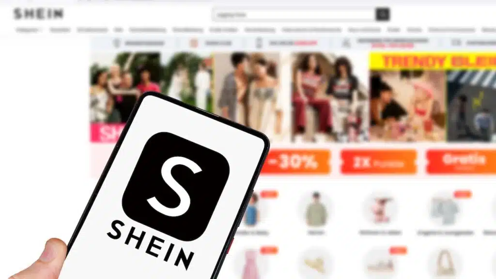 Shein logo online marketplace ecommerce on a mobile phone and computer in Stuttgart, Germany.